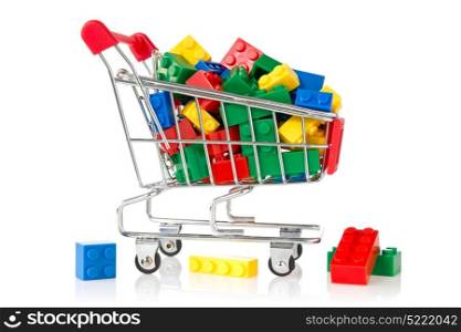 color plastic bricks in a shopping cart on white background