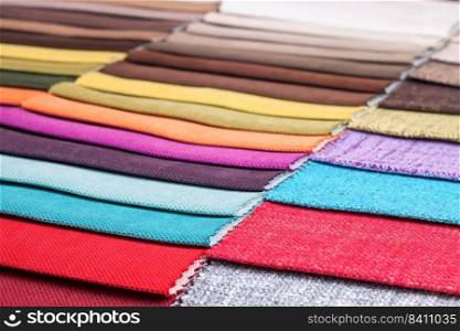 Color s&les of the upholstery fabric in the assortment. palette of fabrics of various colors. Colored tissue s&les