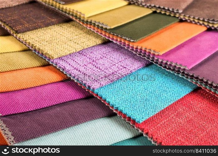Color s&les of the upholstery fabric in the assortment. palette of fabrics of various colors. Colored tissue s&les