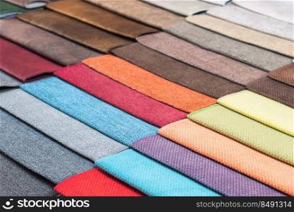 Color samples of the upholstery fabric in the assortment. palette of fabrics of various colors. Colored tissue samples