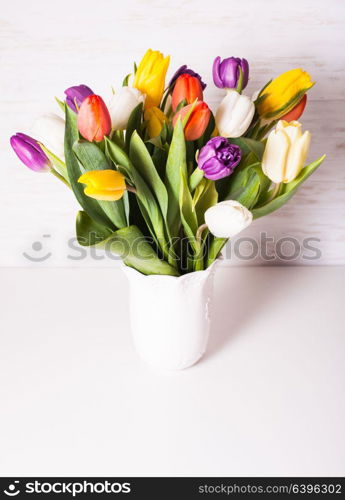 Color tulips in a white vase. Spring concept with copy space. Color tulips in the vase