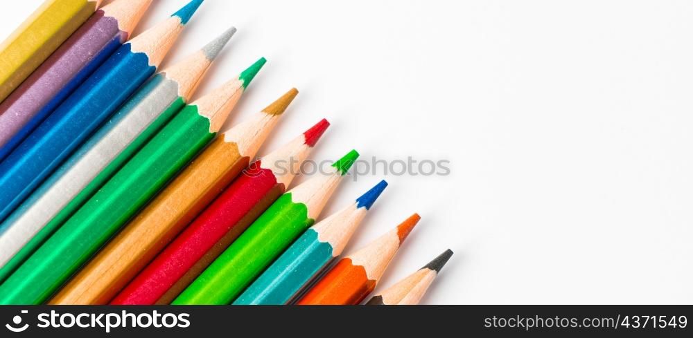 Color wooden pencils isolated on white background. Multi-colored palette for drawing. Place for text. Banner format. Color wooden pencils isolated on white background. Multi-colored palette for drawing, place for text.