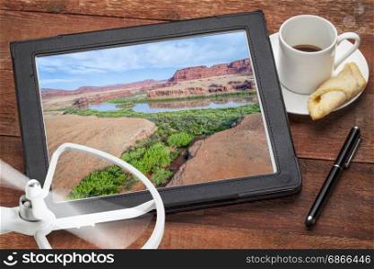 Colorado River canyon in the Moab area, Utah - reviewing and editing aerial image on a digital tablet