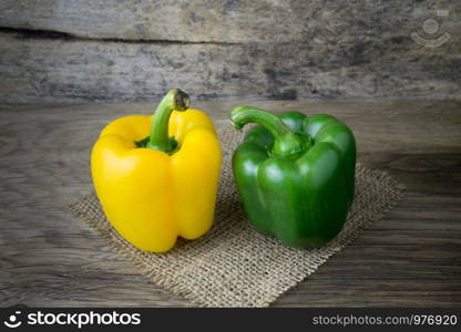 Colored bell peppers on wooden table