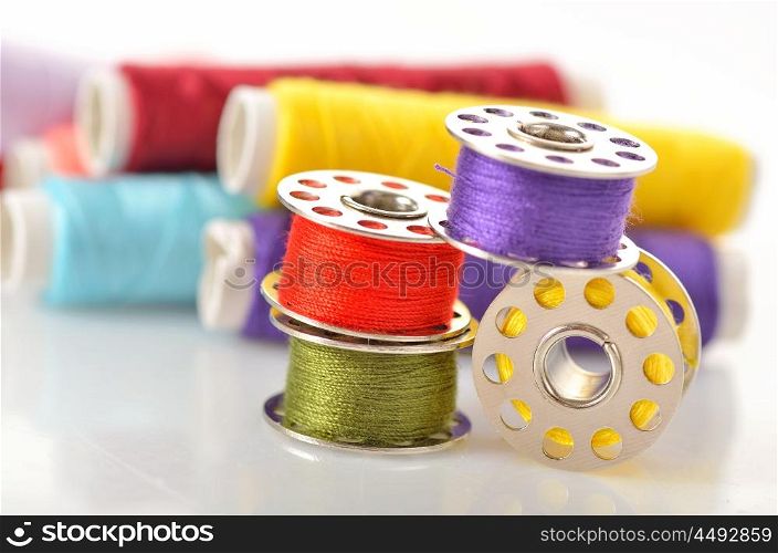 Colored bobbins for machine sewing and threads