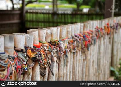 Colored bracelets dedicated to the victims of the killing fields of Choeung Ek in Phnom Penh, Cambodia. Selective focus