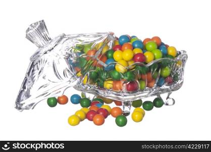 colored candy in a container of crystal on a white background