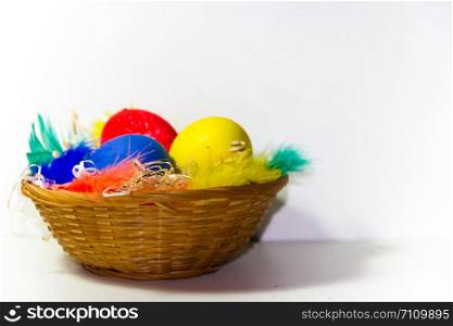 colored easter eggs and nests with colored feathers