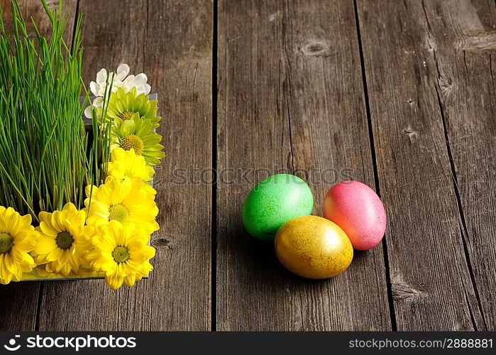 Colored easter eggs on wooden table