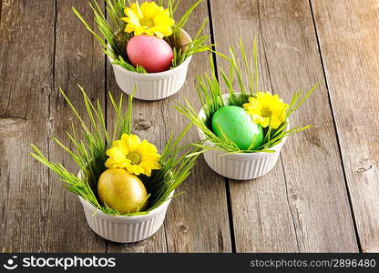 Colored easter eggs on wooden table