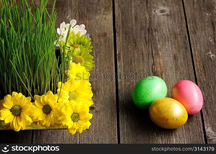 Colored easter eggs on wooden table