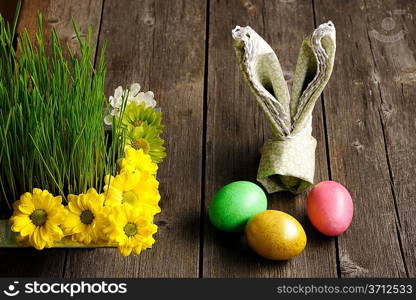 Colored easter eggs on wooden table