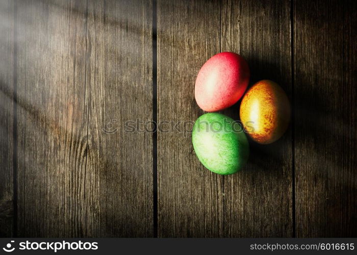 Colored easter eggs on wooden table