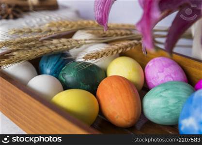 colored eggs wheat ears tray