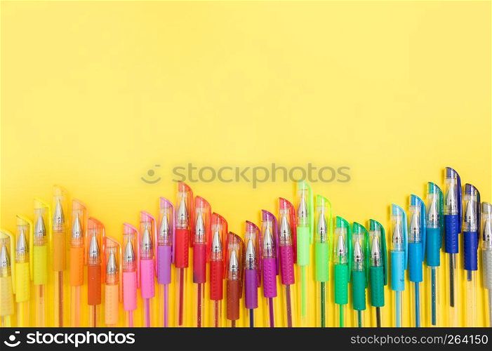 colored felt-tip pens on a pastel colored background