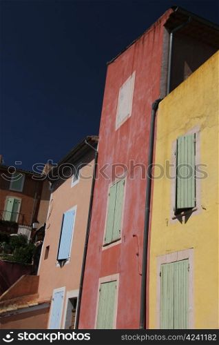 Colored houses in the village of Roussillon, France
