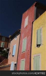 Colored houses in the village of Roussillon, France