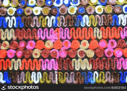 Colored knitted fabric background texture, colorful fabric with a pattern, mat close up, multi-colored canvas, texture of burlap, abstract, fragment colored carpet.