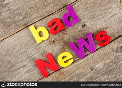 Colored letter magnets spelling text BAD NEWS