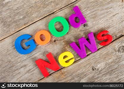 Colored letter magnets spelling text GOOD NEWS