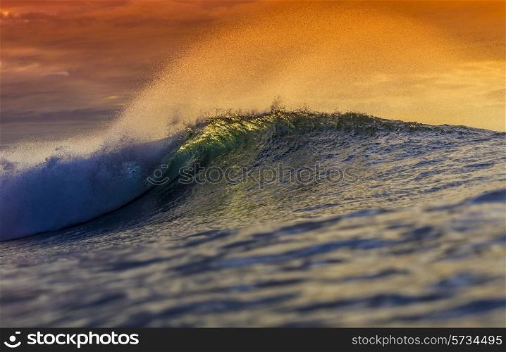 Colored Ocean Wave Falling Down at Sunset Time.