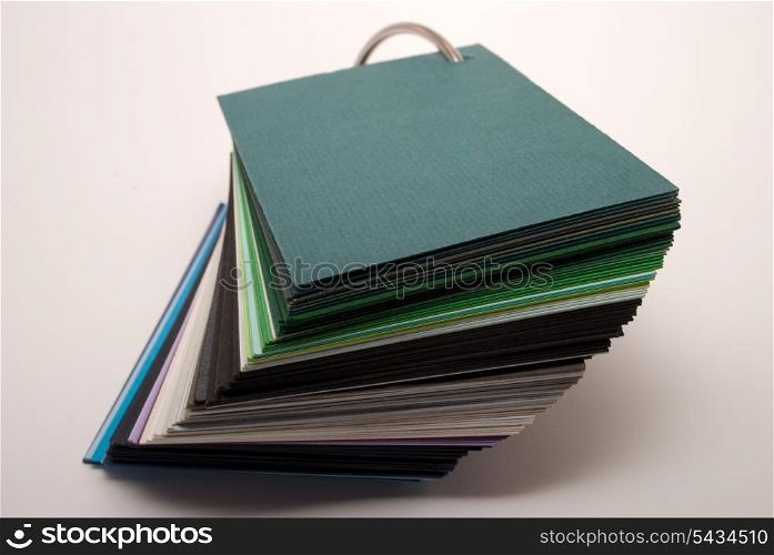 Colored paper stock stand on white background