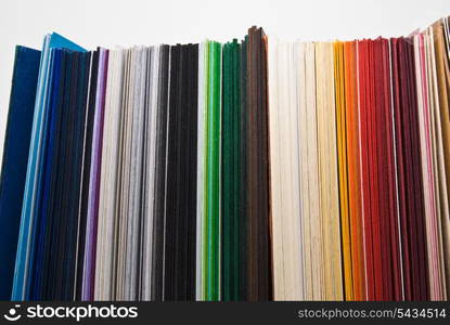 Colored paper stock stand on white background