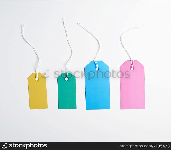 colored paper tags on a white rope, white background, close up