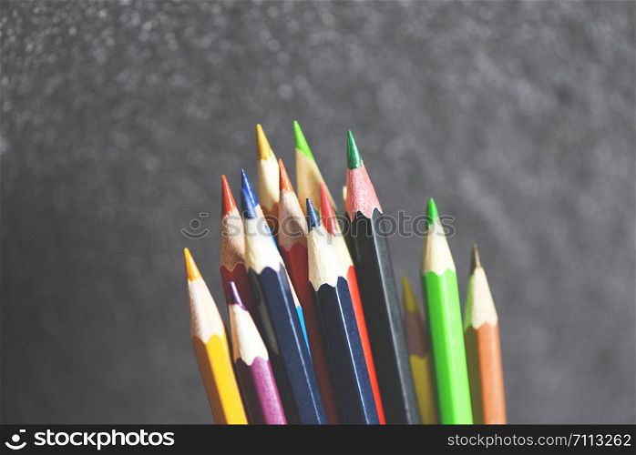 Colored pencil set on blackboard back to school and education concept / Crayons colorful