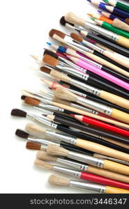 colored pencils and brushes isolated on a white background