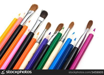 colored pencils and brushes isolated on a white background