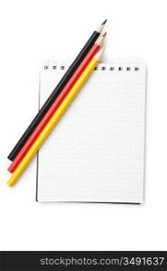 colored pencils and notebook isolated on a white background
