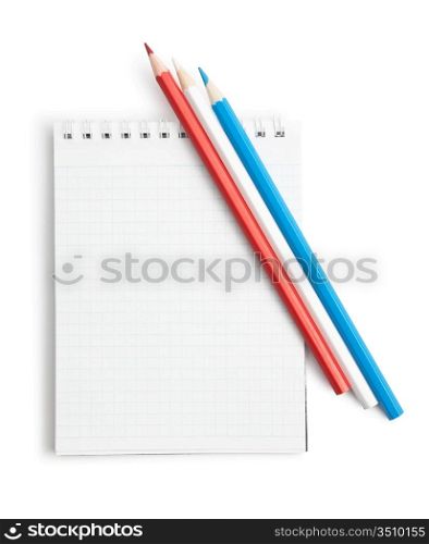 colored pencils and notebook isolated on a white background