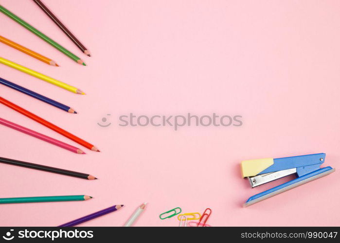 colored pencils and stationery on pink isolated background. top view. flat lay. mockup