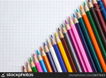 colored pencils at school notebook