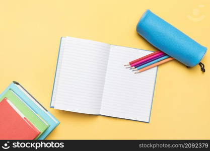 colored pencils composed open notebook with empty pages
