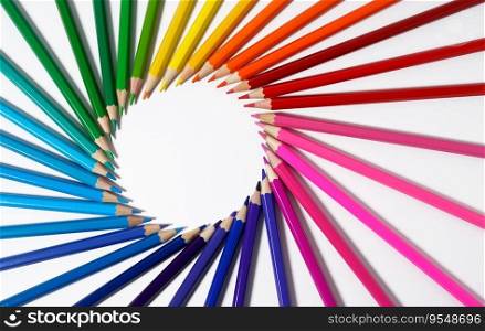Colored pencils forming a round frame with white empty blank copy space. Color pencils concept for creative artwork, drawing and artistic school.