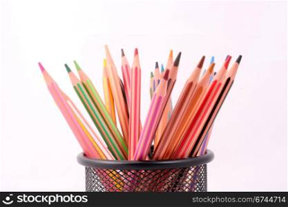 Colored pencils in a pencil holder.
