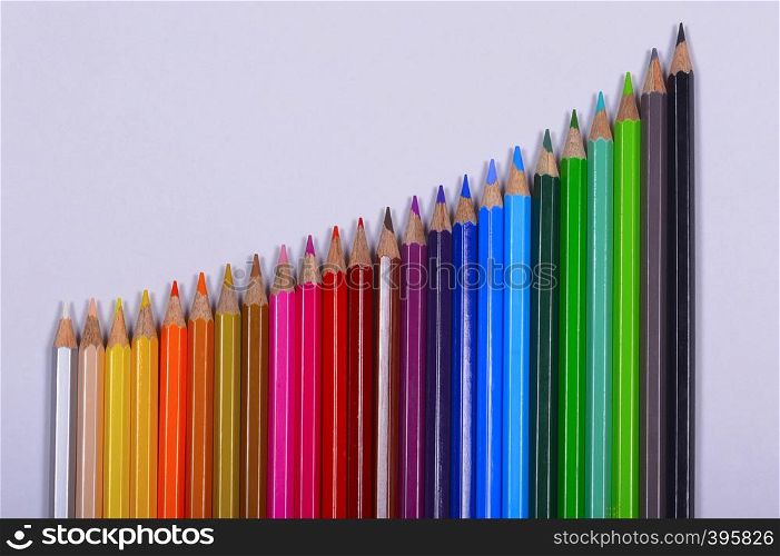 Colored pencils showing graph on white background