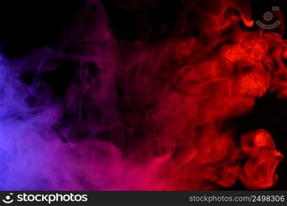 Colored smoke clouds flowing dark abstract background