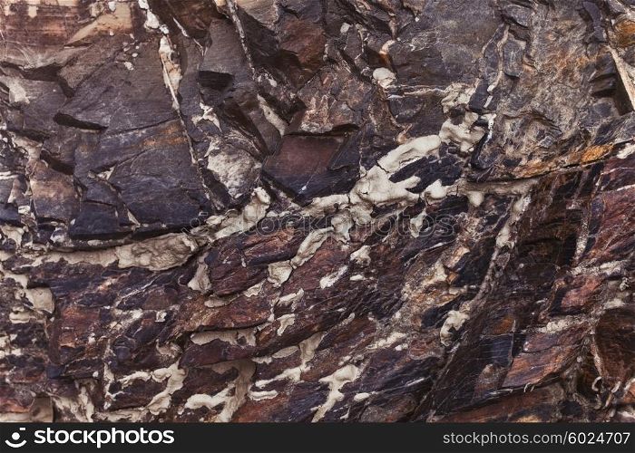 Colored stone texture with cracks close up