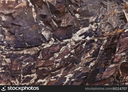 Colored stone texture with cracks close up