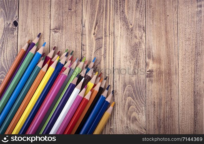 Colored wooden pencils, on a wooden base. education and school concept.