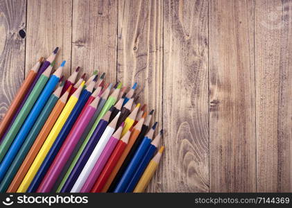 Colored wooden pencils, on a wooden base. education and school concept.