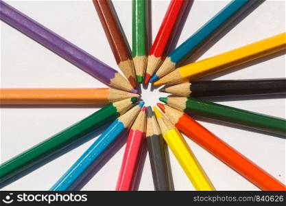 Colored wooden pencils on white background