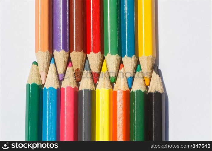 Colored wooden pencils on white background