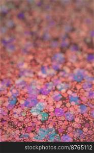Colorful abstract background made of sequins with bokeh.. Pink abstract glitter background with shiny bokeh