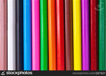 Colorful abstract pattern of wooden colored crayon pencils background textured.