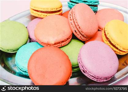 colorful almond cookies on pink background