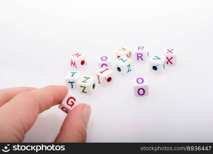 Colorful alphabet letter cubes in handon a white background